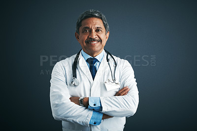 Buy stock photo Studio portrait of a confident mature doctor against a gray background