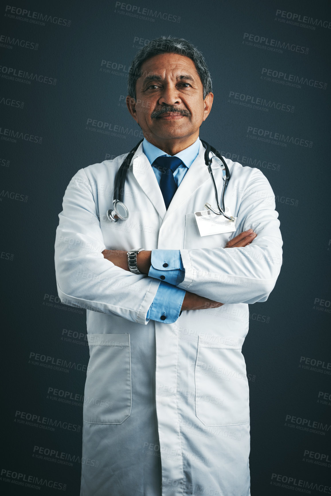 Buy stock photo Studio portrait of a confident mature doctor against a gray background