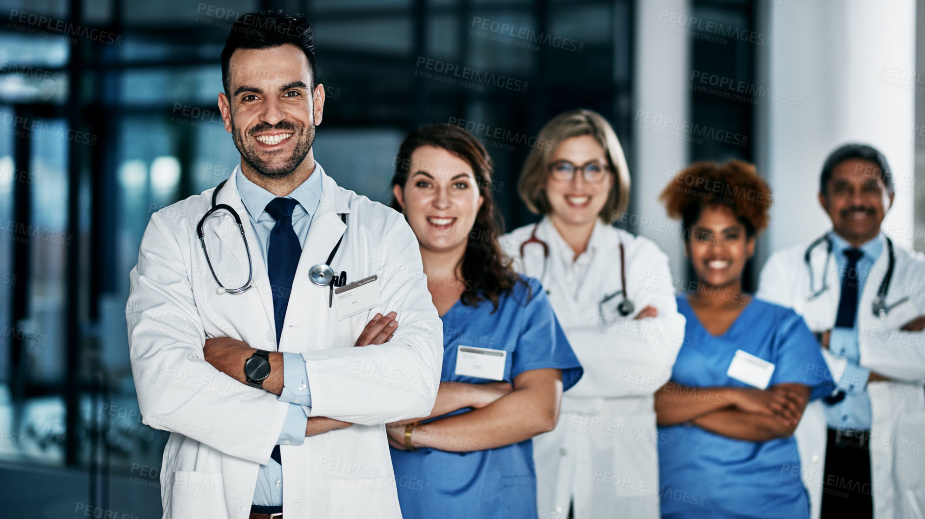 Buy stock photo Portrait of a team of confident doctors standing together in a hospital