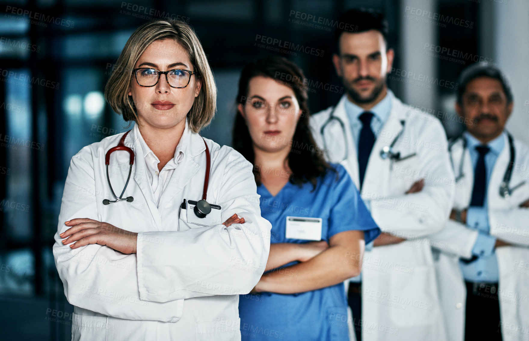 Buy stock photo Portrait of a team of confident doctors standing together in a hospital