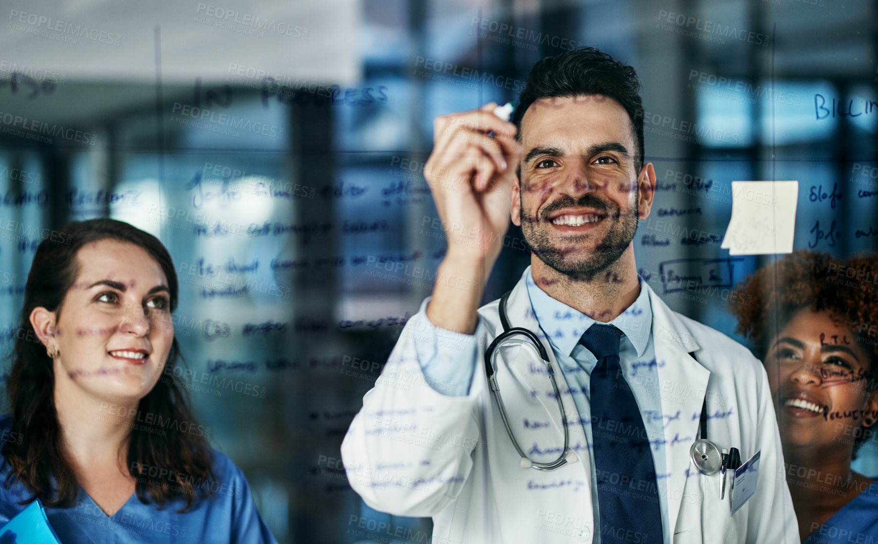 Buy stock photo Shot of a team of doctors having a brainstorming session in a hospital