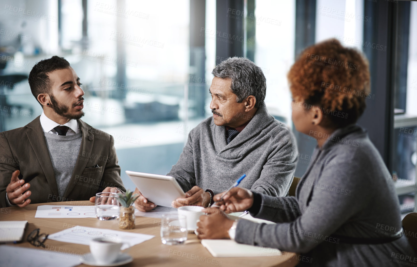 Buy stock photo Shot of a group of businesspeople having a meeting in an office