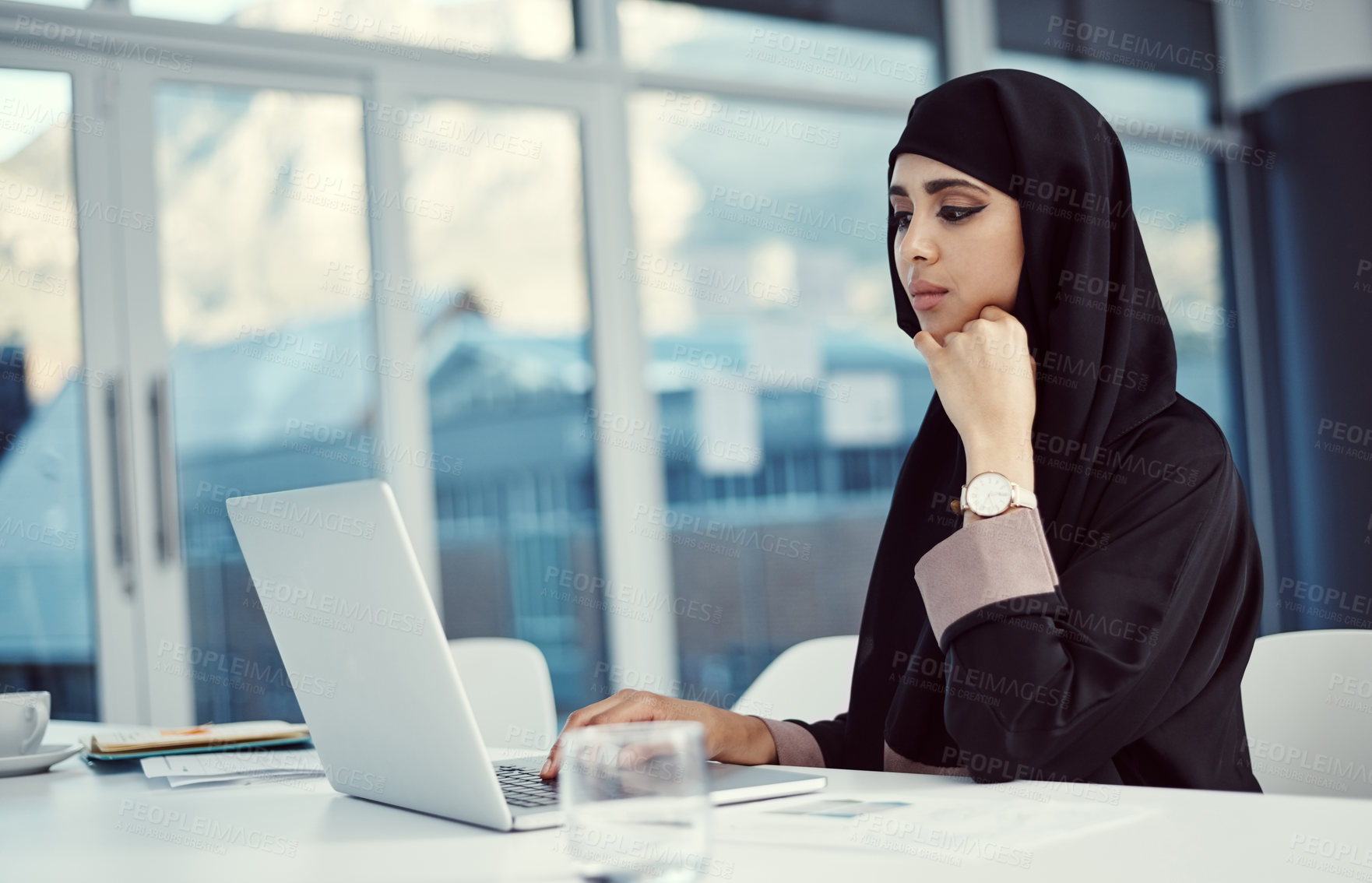 Buy stock photo Islamic, woman and thinking with laptop in office for news story angle, article inspiration or editing. Muslim, journalist and thoughtful with tech at agency for planning newsletter and proofreading