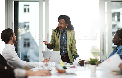 Buy stock photo Shot of a businesswoman giving a presentation to her colleagues in a boardroom