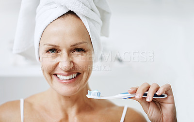 Buy stock photo Cropped shot of a mature woman posing with a toothbrush