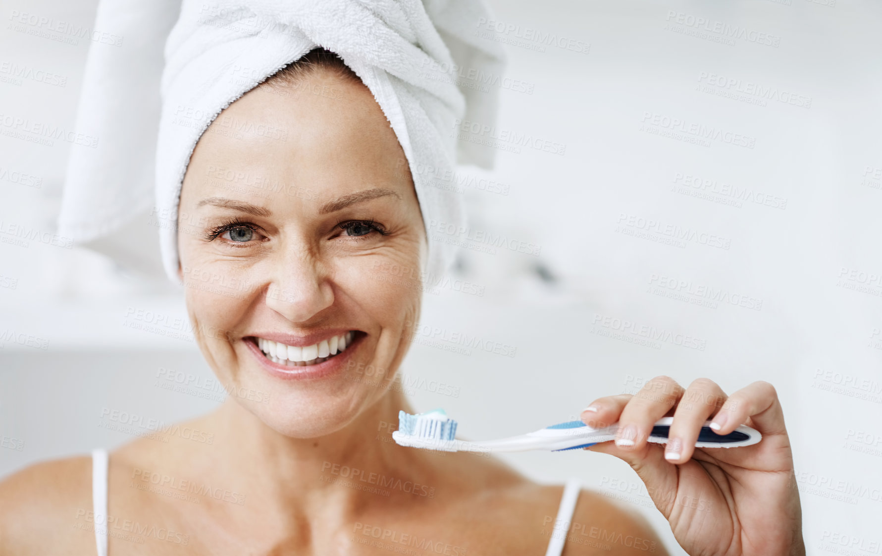 Buy stock photo Cropped shot of a mature woman posing with a toothbrush