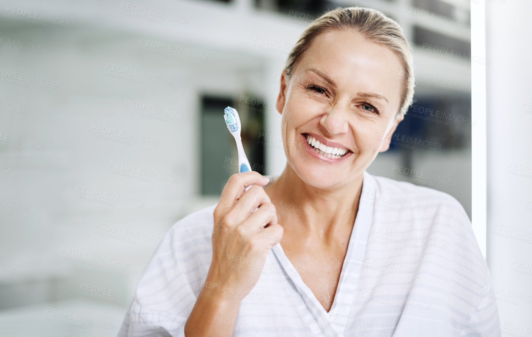 Buy stock photo Cropped shot of a mature woman posing with a toothbrush