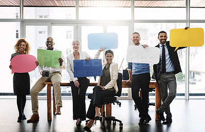 Buy stock photo Portrait of a group of businesspeople holding speech bubbles in an office