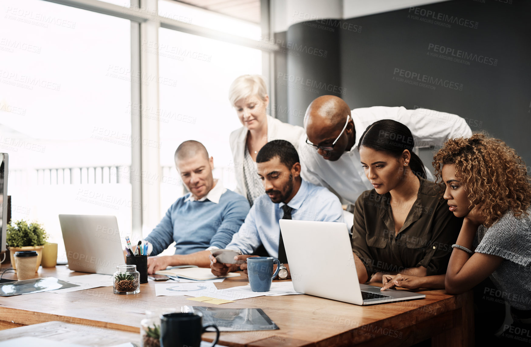 Buy stock photo Shot of a group of businesspeople working in an office