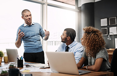 Buy stock photo Shot of a businessman giving a presentation to his colleagues in an office