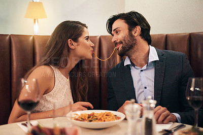 Buy stock photo Love, happy and spaghetti with couple in restaurant sharing for romance, valentines day and date. Bonding, smile and celebration with man and woman with pasta at table for fine dining, wine and cute