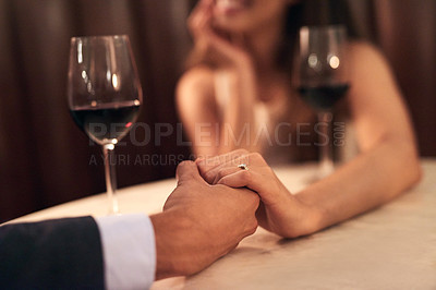 Buy stock photo Couple, holding hands and dinner date with wine for valentines day, romance or fine dining at night on table. Hand of man and woman touching in love, care or celebration for anniversary at restaurant