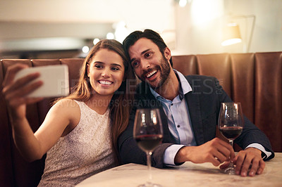 Buy stock photo Selfie, wine and valentines day with a couple in a restaurant for a romantic fine dining celebration of love. Photograph, alcohol or anniversary with a man and woman celebrating a milestone together