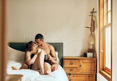 Buy stock photo Kiss, coffee or couple in hotel bedroom for affection with love, bonding and relationship for pleasure. Drinking tea, morning and people in home on valentines day, romantic anniversary or passion