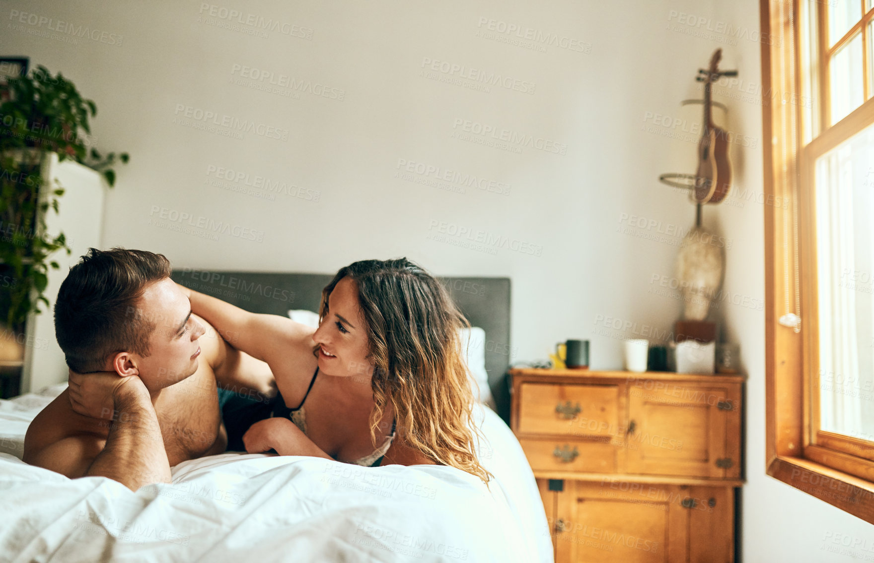 Buy stock photo Talking, romance or couple in hotel bedroom for affection with love, bonding or relationship for trust. Relax, apartment and happy people in home on valentines day, anniversary or morning passion