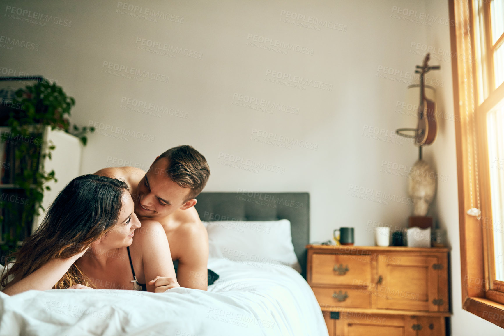 Buy stock photo Laughing, romantic or couple hug in bedroom for affection with love, bonding or relationship for trust. Relax, apartment and happy people in hotel on valentines day, anniversary or morning passion