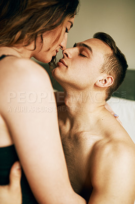 Buy stock photo Shot of an affectionate young couple sharing a romantic moment at home