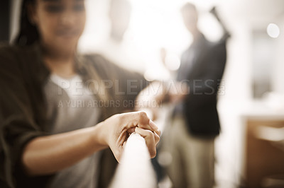 Buy stock photo Business competition, rivalry or challenge of a woman pulling a rope in the office. Corporate professional having a dispute at a company or workplace. Employees playing tug of war for team building
