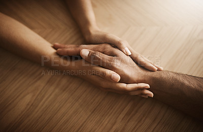 Buy stock photo Holding hands, depression and support with people at wooden table from above for comfort or empathy. Anxiety, love and trust with friends in home together for help in crisis of grief, loss or pain