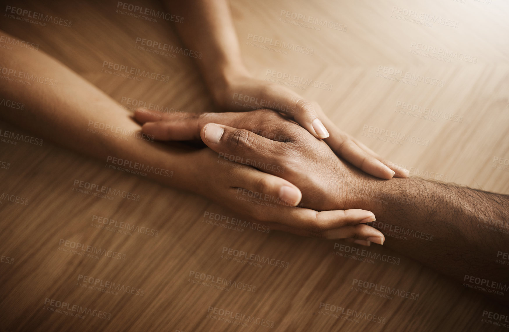 Buy stock photo Holding hands, depression and support with people at wooden table from above for comfort or empathy. Anxiety, love and trust with friends in home together for help in crisis of grief, loss or pain