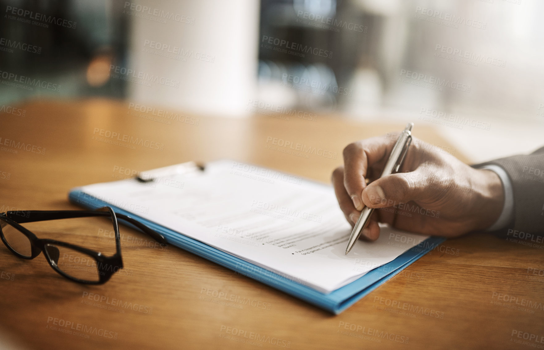 Buy stock photo Lawyer hand showing paperwork for signing, agreement contract and settlement offer in law firm office. Closeup of legal advisor, attorney and paralegal pointing with pen to accept or close court case