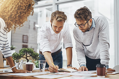 Buy stock photo Writing, group and planning with paperwork in meeting, creative and brainstorming of interior designer. Explaining, employees and reading for collaboration, ideas and people in office for project