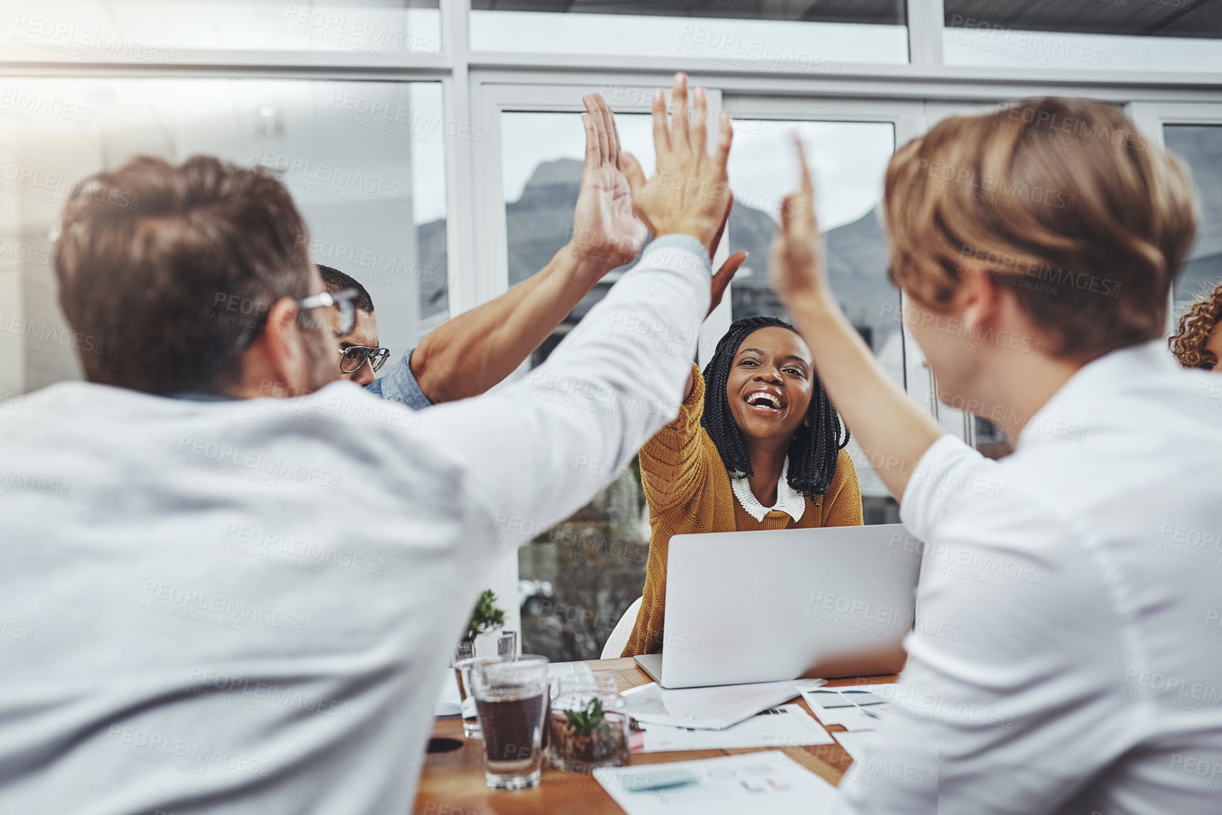 Buy stock photo Cropped shot of colleagues high-fiving in the office