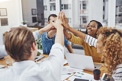 Buy stock photo Cropped shot of colleagues high-fiving in the office
