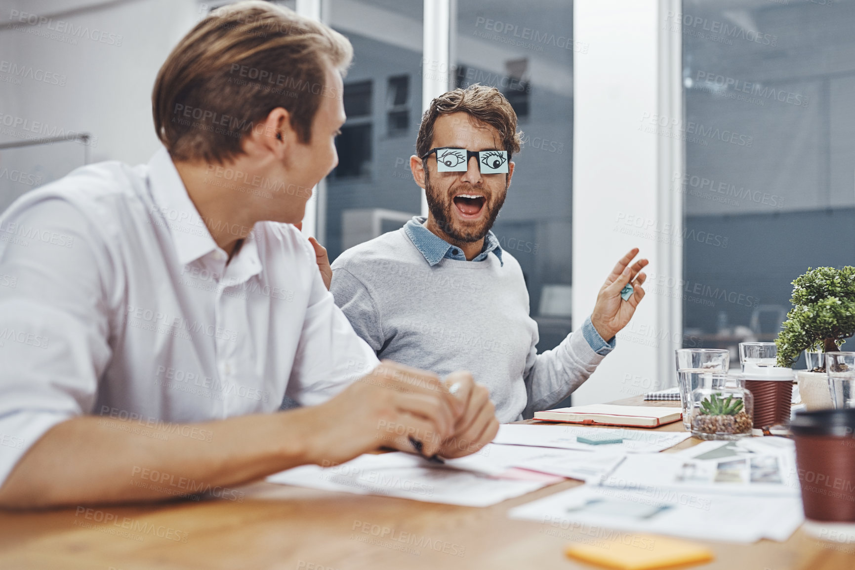 Buy stock photo Office, team and funny business men in meeting with eye stickers on glasses for joke in creative startup. Laughing, comic and happy employees together with crazy, silly friends and comedy discussion