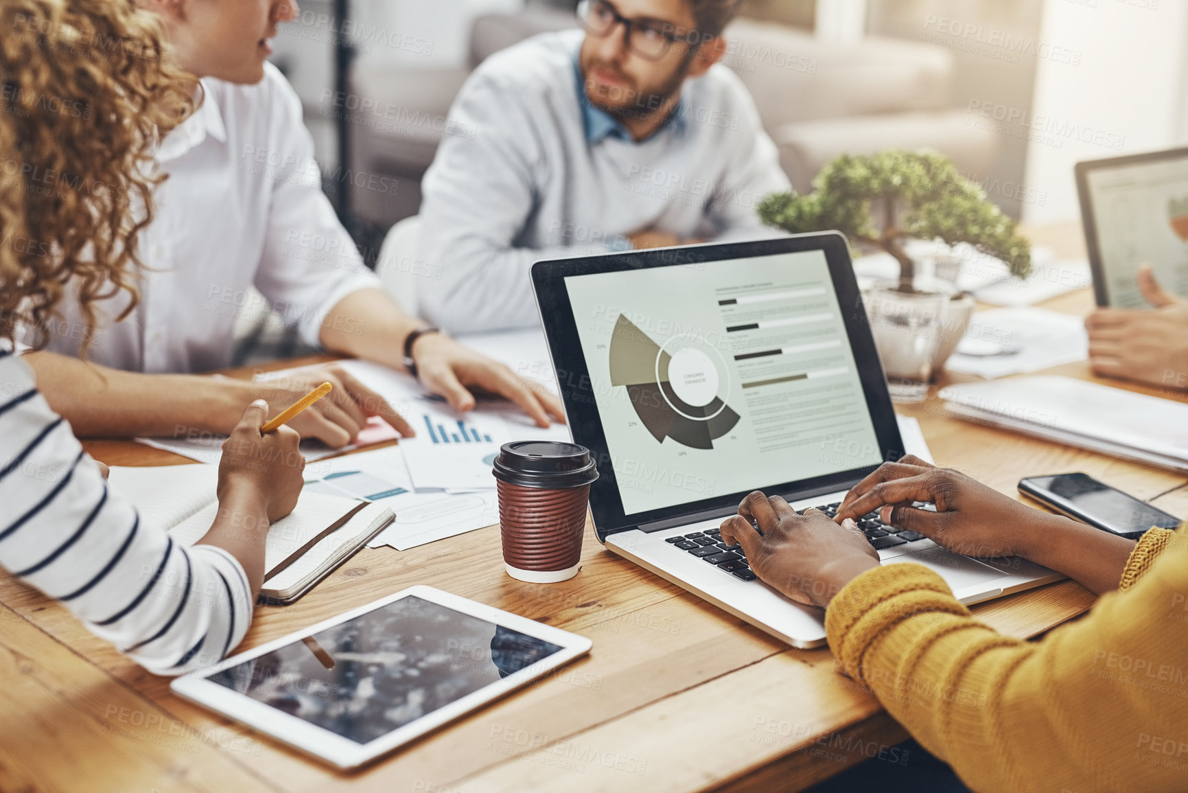 Buy stock photo High angle shot of unrecognizable colleagues having a meeting in the office