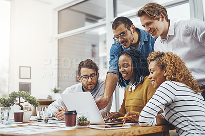 Buy stock photo Cropped shot of a group of businesspeople looking at something on a laptop