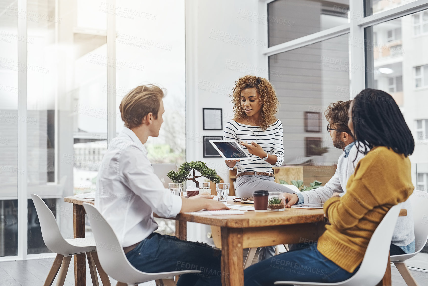 Buy stock photo Cropped shot of a group of businesspeople having a meeting in an office