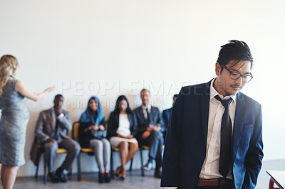 Buy stock photo Shot of a group of confident businesspeople waiting in line for their interviews inside of a office during the day