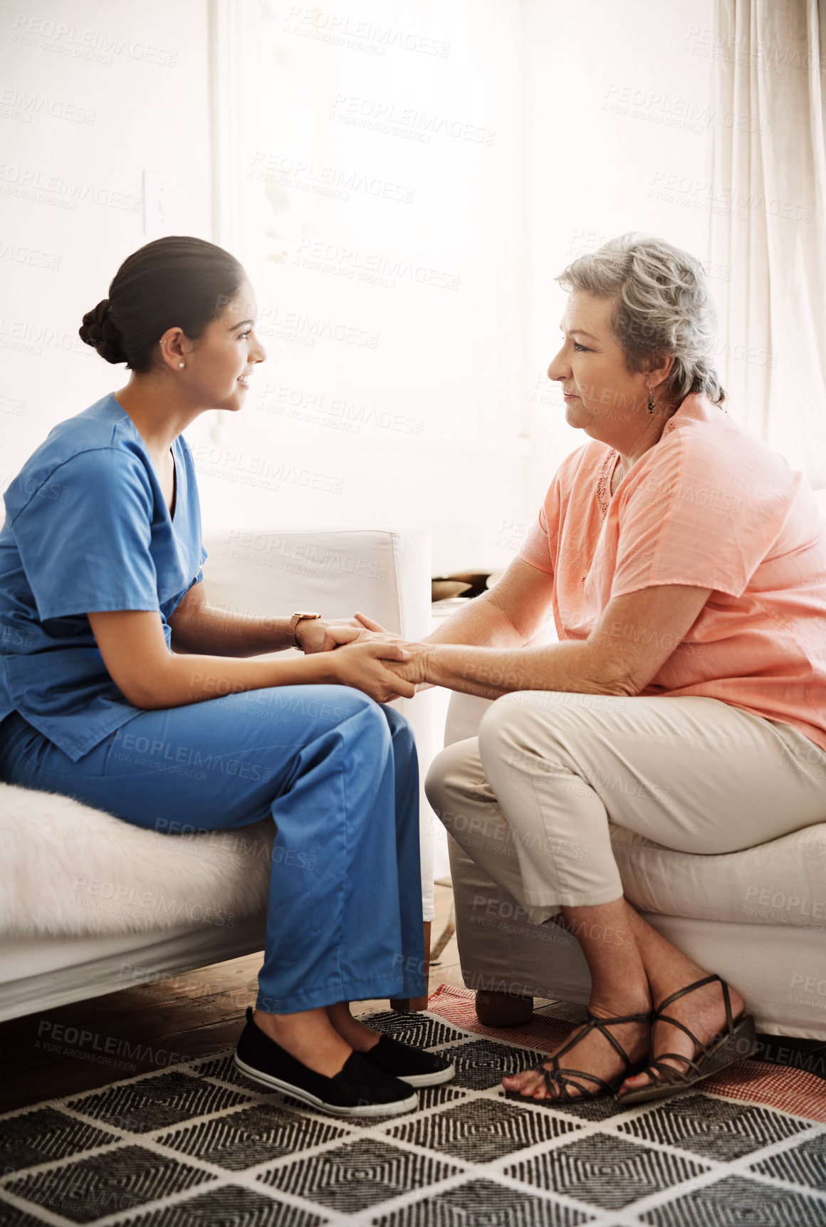 Buy stock photo Holding hands, caregiver and elderly woman on sofa with advice for health, consulting or compassion. Lens flare, nurse and senior patient for hope, trust or medical conversation at retirement home