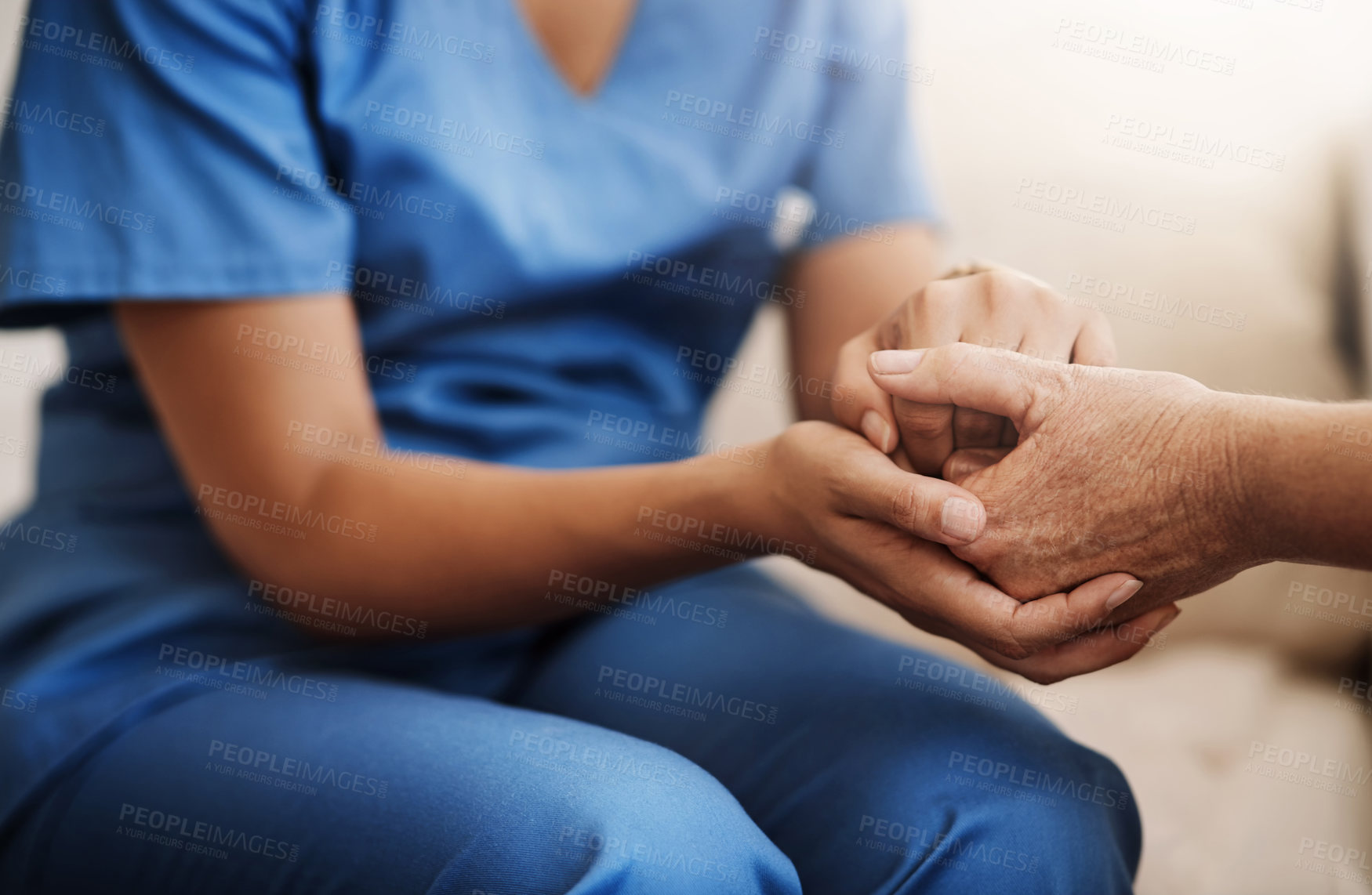 Buy stock photo Cropped shot of an unrecognizable nurse holding a senior woman's hands in comfort
