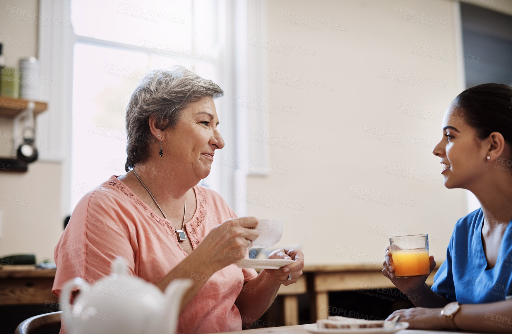 Buy stock photo Woman, caregiver and conversation of advice in nursing home for breakfast, relax or support of medical consultation. Nurse, patient and talk for senior care by helping, trust or counselling service