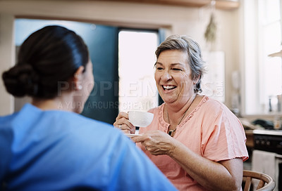 Buy stock photo Retirement, caregiver and happy woman in kitchen for support, kindness and healthcare. Tea, talking and medical worker or nurse with senior female person in home for conversation, advice or chat