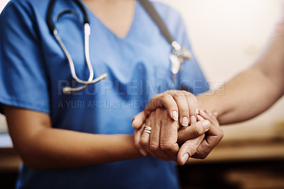Buy stock photo Cropped shot of an unrecognizable female nurse holding a senior woman's hands in comfort