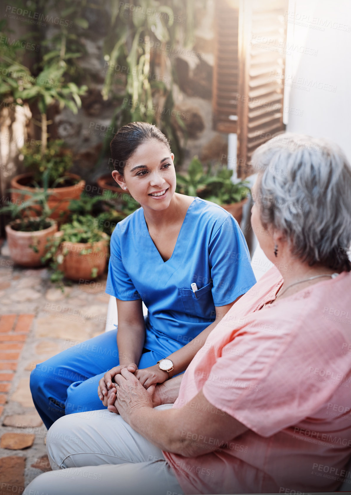 Buy stock photo Therapy, caregiver and senior woman in garden for consultation, kindness and mental health. Happy, discussion and medical worker or nurse an retired female person in home for conversation and support