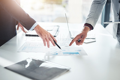 Buy stock photo Cropped shot of two unrecognizable businessmen discussing paperwork at the table in the boardroom