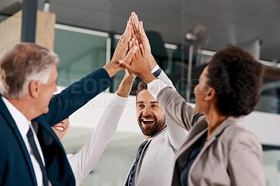 Buy stock photo Shot of a group of businesspeople high fiving together in an office