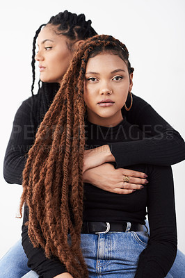 Buy stock photo Sisters, portrait and fashion in studio, hug and style bonding on white background. Women, friends and embrace for relationship on backdrop, casual outfit and twins matching for trend or support