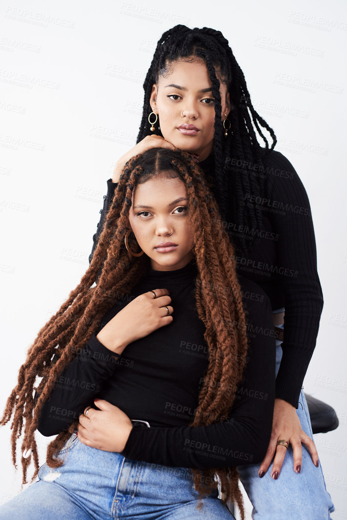 Buy stock photo Lesbian women, portrait and fashion in studio with confidence for style inspiration, blue jeans and love. Serious, lgbt and black people together for support with couple, relationship and dreadlocks