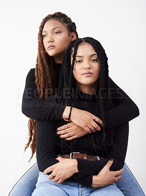 Buy stock photo Women, portrait and style in studio, hug and trust bonding on white background. Sisters, friends and embrace for relationship on backdrop, designer clothes and twins matching for trend or support