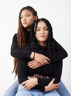 Buy stock photo Women, portrait and fashion in studio, hug and style bonding on white background. Sisters, friends and embrace for relationship on backdrop, casual clothes and twins matching for trend or support