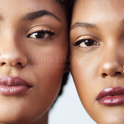 Buy stock photo Studio shot of two beautiful young women posing against a grey background