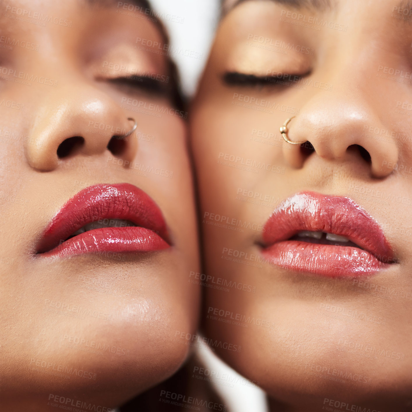 Buy stock photo Studio shot of two beautiful young women posing against a grey background