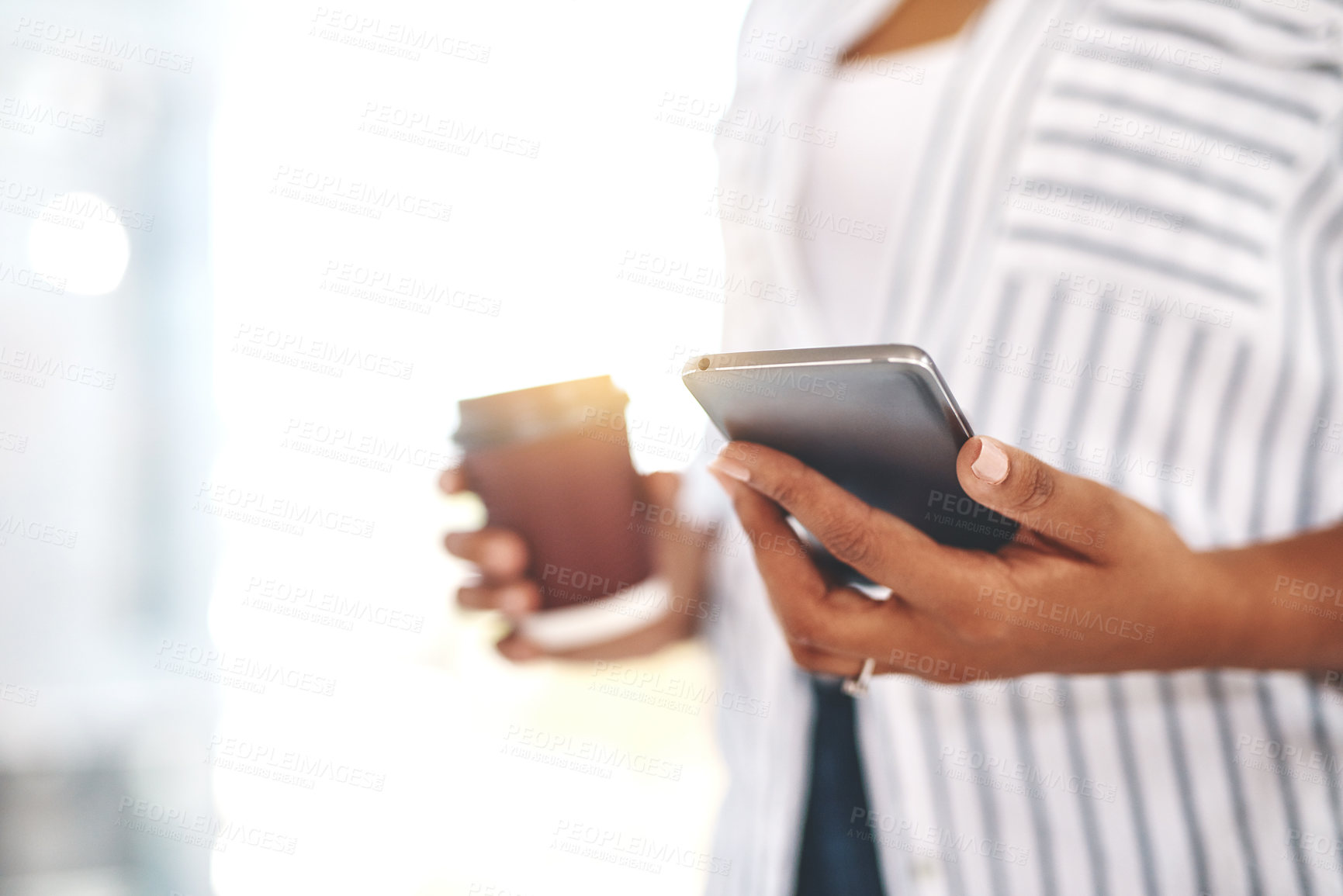 Buy stock photo Closeup of professional business woman on her phone working and replying to messages, emails or social media with flare. Black female businessperson holding work and personal cellphone in her office