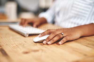 Buy stock photo Hand on a mouse, clicking and scrolling while browsing online and surfing the internet. Closeup of a woman using a computer while sitting at a wooden desk. Connect with wireless bluetooth technology
