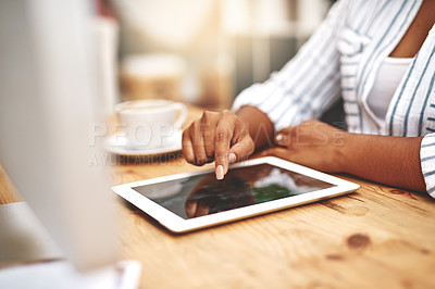Buy stock photo Female african hand using a tablet at a desk doing office work. Closeup of a professional woman browsing on social media while having a cup of tea or coffee. Businesswoman doing research online.